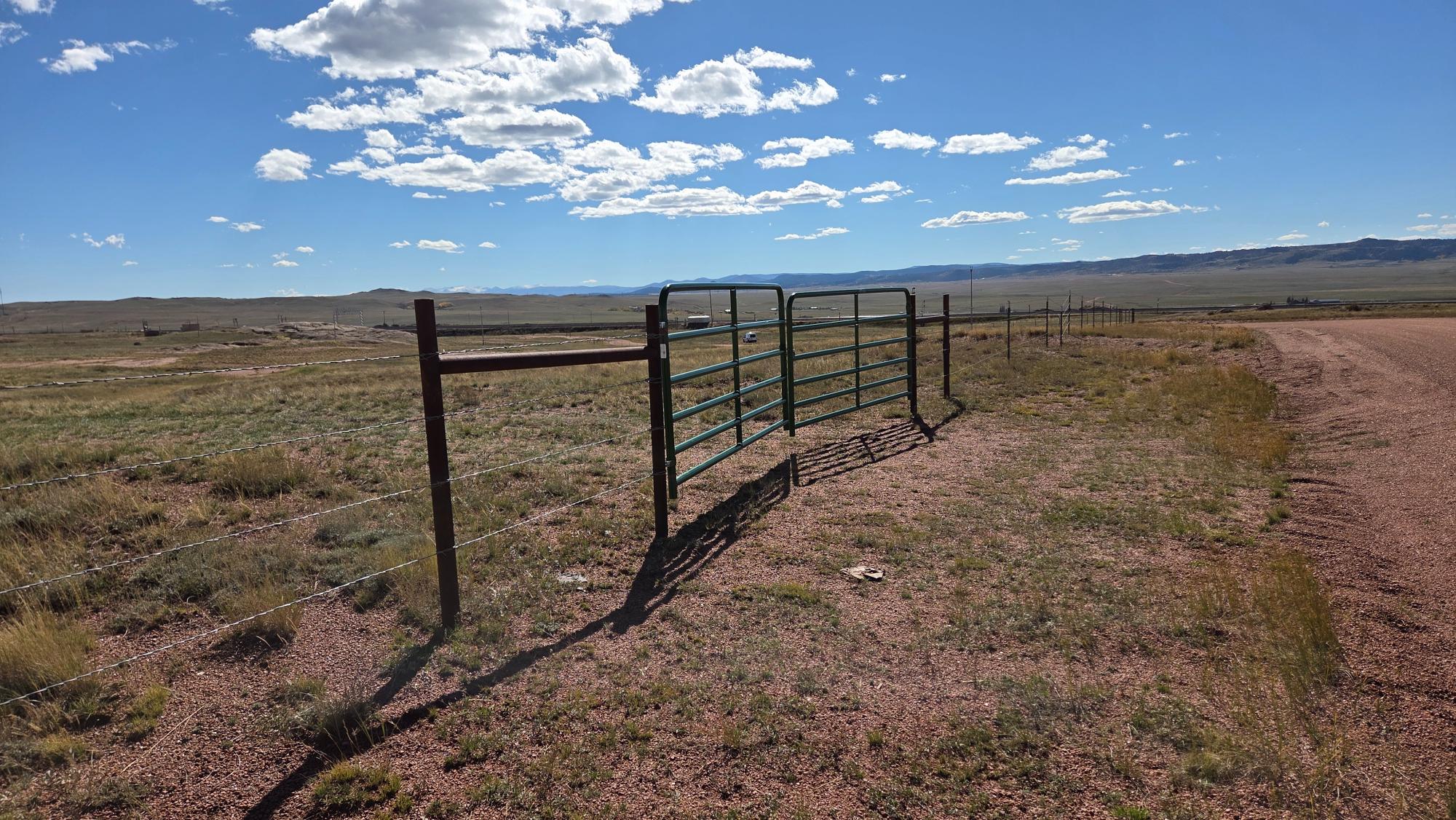 (17) main gate entrance to property from road view