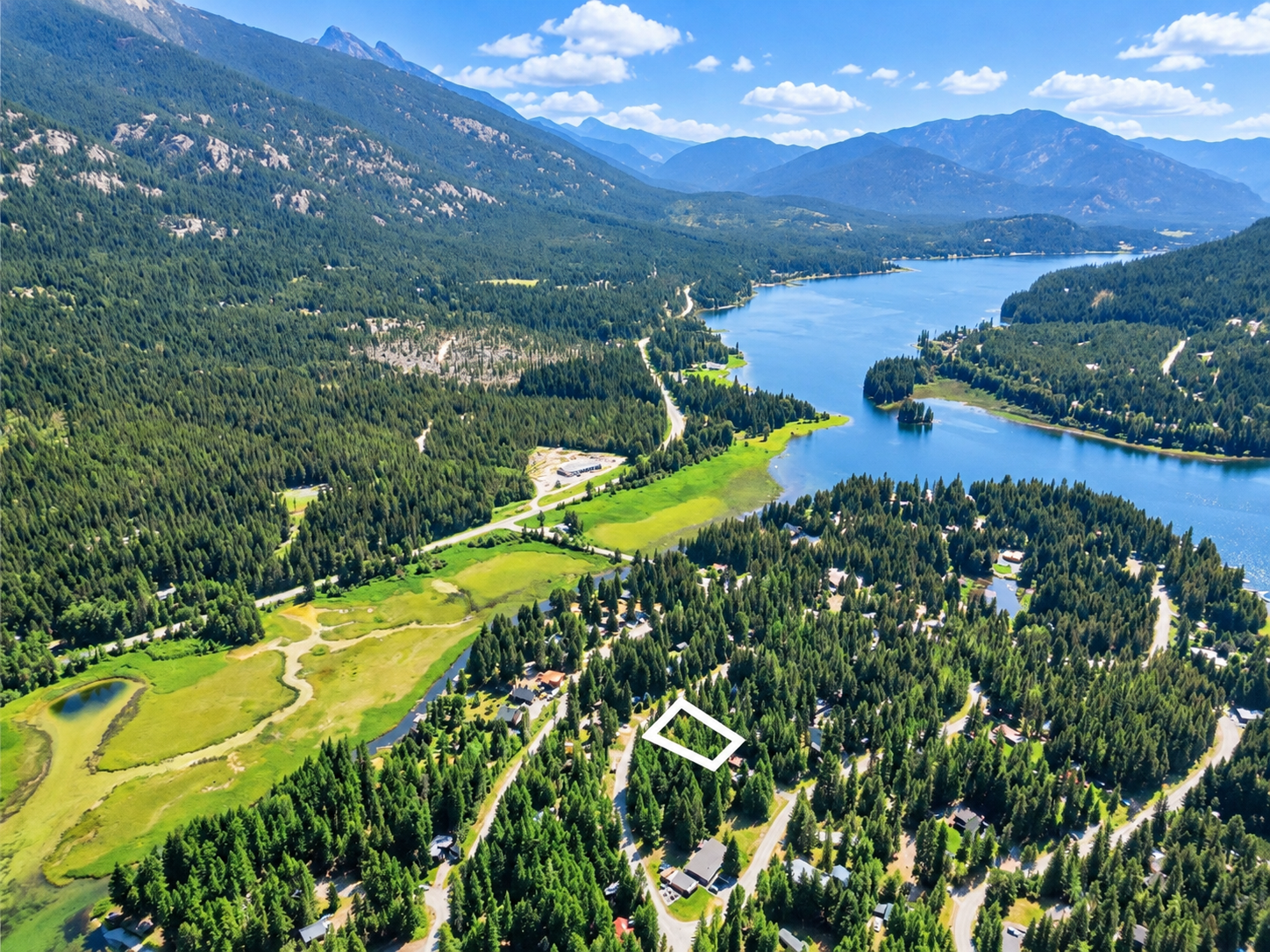 Wide aerial of Bull Lake with the 0.26-acre Angel Island lot for sale outlined in white
