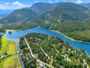 Drone view of Bull Lake shoreline, evergreen mountain slopes and the Angel Island neighborhood