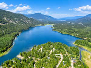 Aerial photo of Bull Lake with the 0.26-acre Angel Island lot for sale outlined among trees and homes