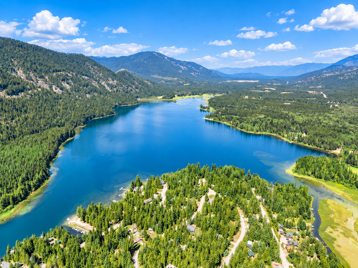 Aerial view of Bull Lake and forested mountains surrounding the Angel Island community near Troy, Montana