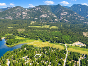 Outlined 0.26-acre wooded lot with Bull Lake shoreline and mountains behind it near Troy, MT