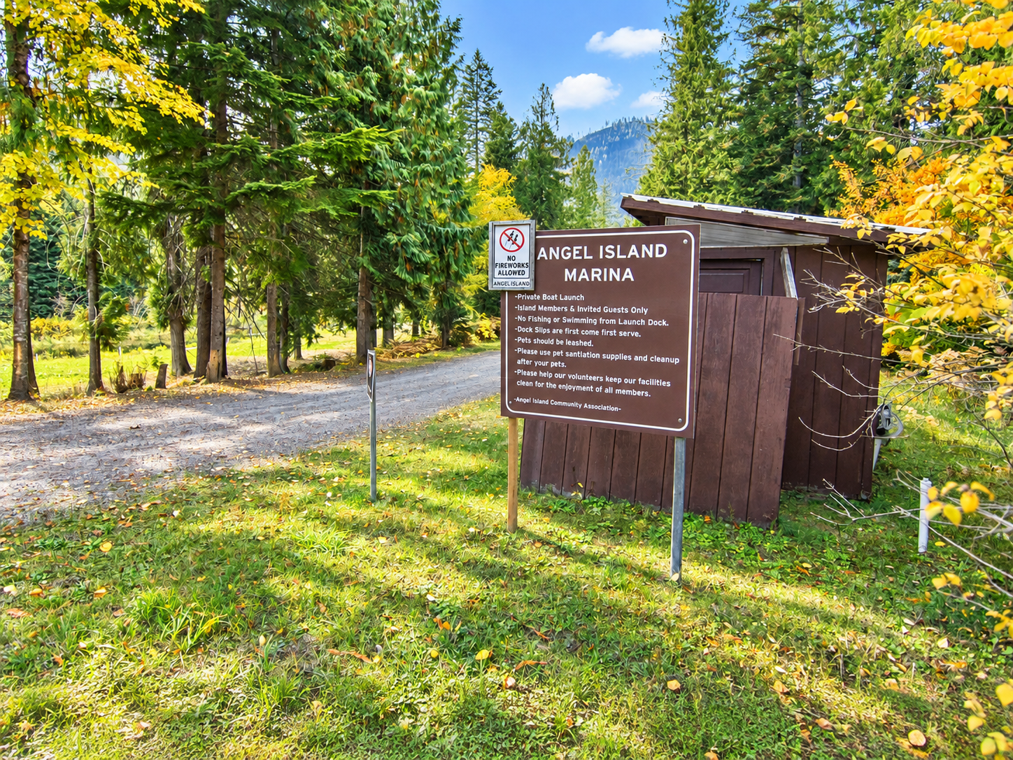 Angel Island Marina sign beside a wooded road near Bull Lake in Lincoln County, Montana